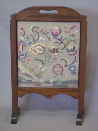 A 1930's mahogany firescreen with Berlin woolwork panel 18"