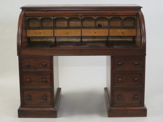 A Victorian mahogany cylinder bureau, the cylinder revealing a well fitted interior, the pedestals fitted 6 drawers 55"