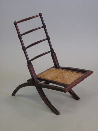 A Victorian mahogany ladder back folding chair with woven  Berlin seat