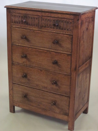 A carved oak chest of 2 short and 4 long drawers with arcaded  decoration and tore handles 33"