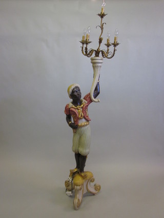 A Blackamoor supporting a gilt metal 3 light candelabrum   ILLUSTRATED