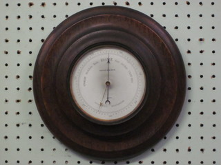 An aneroid barometer with enamelled dial by David Stalker of  Leith contained in a turned wooden case
