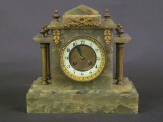 A French Victorian 8 day striking mantel clock with enamelled  dial and Arabic numerals contained in a marble architectural case