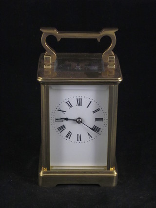 A 19th Century French striking carriage clock with enamelled  dial and Roman numerals contained in a gilt metal case   ILLUSTRATED