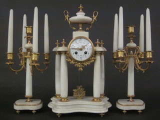 A 19th Century French 3 piece clock garniture comprising  striking clock with enamelled dial and Arabic numerals contained  in a white marble case surmounted by a lidded urn together with  a pair of 5 light candelabrum  ILLUSTRATED