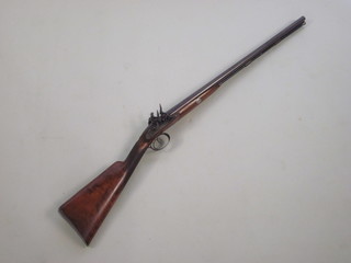A Manton double barrelled flint lock shot gun with Damascus barrels 27 1/2", the locks marked John Manton & Sons Patent  with walnut stock  ILLUSTRATED