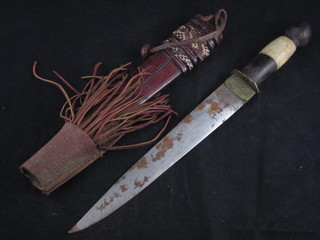 An Eastern dagger with 9 1/2" blade and a horn handle,  contained in a leather scabbard