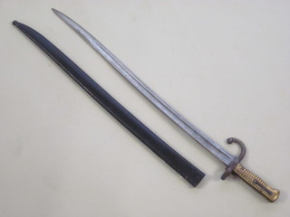 A French chassepot bayonet, the blade dated 1872 contained in a metal scabbard