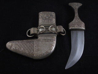 A Jambuka with 5 1/2" blade contained in an embossed white  metal scabbard