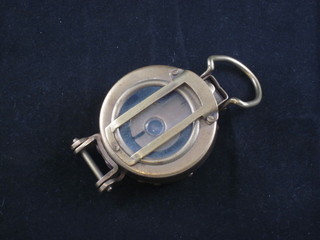 A reproduction military brass prasmatic compass
