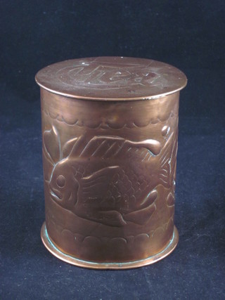 A cylindrical Newlyn embossed copper tea caddy decorated  diving fish, the lid embossed TEA, 4"