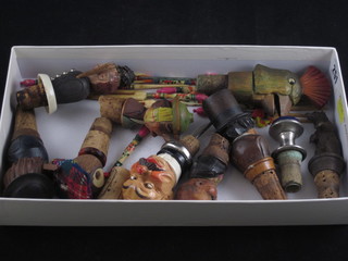 A collection of various carved wooden bottle stoppers