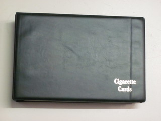 A green plastic album of cigarette cards