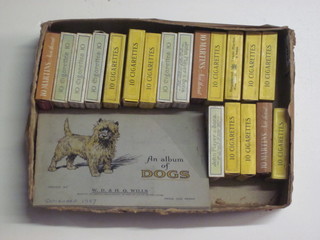 A Wills album of cigarette cards - Dogs and a collection of various cigarette packets containing cigarette cards