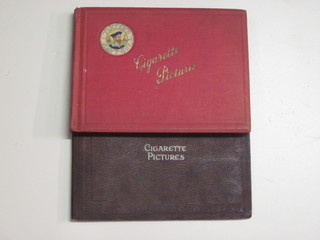 A red Players album of cigarette cards and a brown album  containing cigarette cards