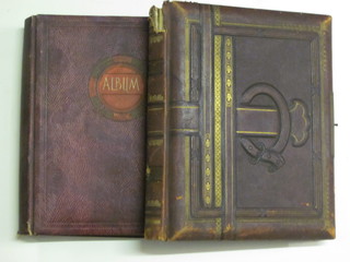 A Victorian red leather bound musical photograph album, f,  together with a red album of various postcards
