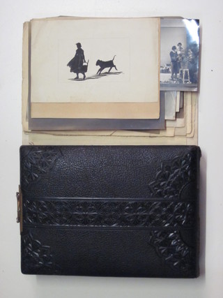 A Victorian black leather album containing various black and  white photographs together with a small collection of photographs