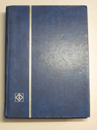 A blue stock book of Victorian and later stamps