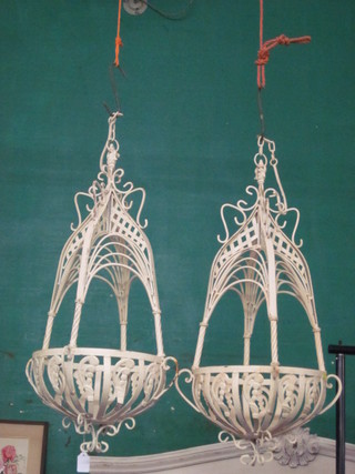 A pair of white painted iron hanging baskets