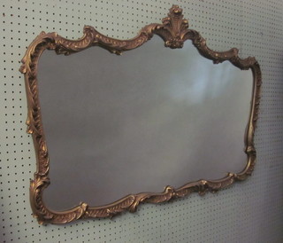 A shaped plate wall mirror contained in a decorative gilt frame 41"