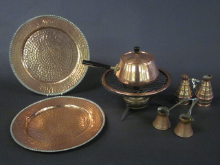 A circular copper fondue set, 2 circular planished copper trays and 2 measures