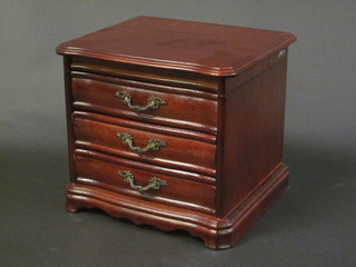 A wooden jewellery box in the form of a miniature chest with hinged lid