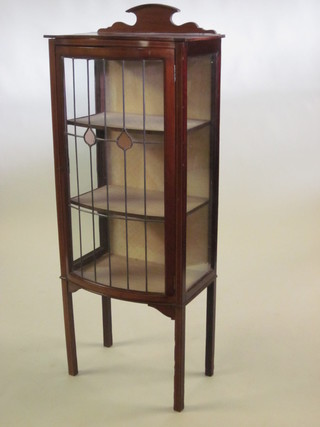 An Edwardian bow front inlaid mahogany display cabinet with  raised back, enclosed by lead glazed panelled doors, raised on  square supports 22"