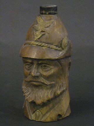 A bottle contained in a carved wooden mount in the form of a  bearded helmeted gentleman 9"