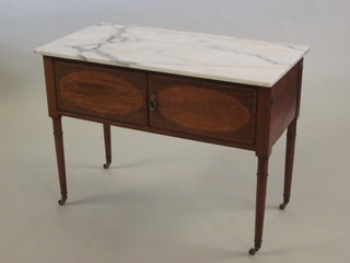 An Edwardian inlaid mahogany wash stand with white veined  marble top enclosed by panelled doors, raised on turned supports  42"