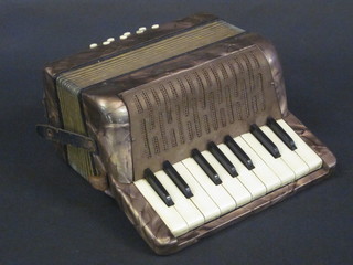 A childs Hohner Mignon accordion with 8 buttons