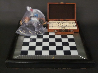 A chess board complete with a set of draughts and 2 sets of  dominoes