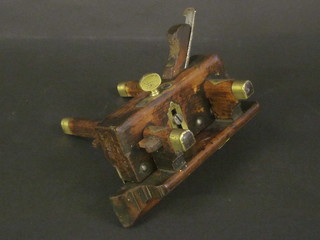 A wooden and brass moulding plane