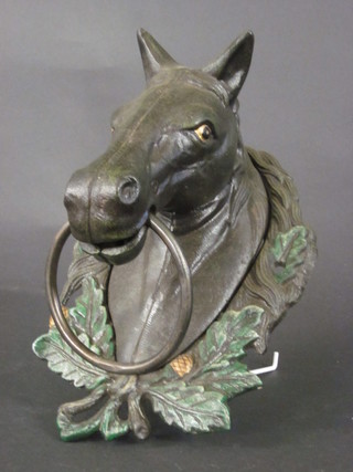 A decorative iron tethering bracket in the form of a horses head 12"