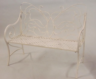 An iron pierced metal folding bench with butterfly shaped back 48"