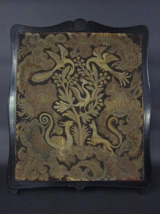 A machine made tapestry panel contained in an ebonised frame
