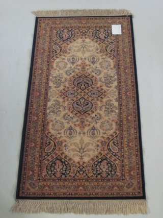 A machine made Persian style blue ground rug 68" x 35"