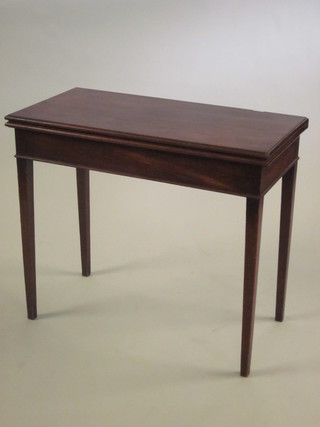 A 19th Century rectangular mahogany tea table, raised on square tapering supports 34"