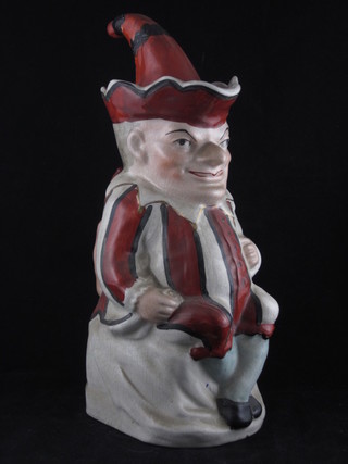 A 19th Century Staffordshire Toby jug in the form of a seated Mr Punch complete with hat 12"