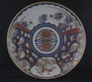A 19th Century Japanese Imari circular porcelain dish with panel decoration, the reverse with 4 character mark 13"