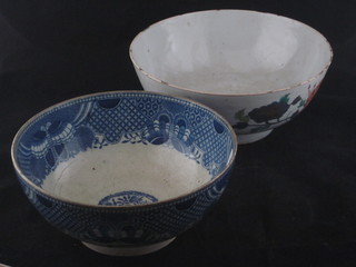 An Oriental famille vert porcelain bowl decorated birds, star  crack to base 9", and a 19th Century blue and white pottery bowl  decorated in the Oriental manner