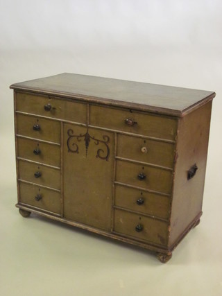 A Victorian green painted pine trunk in the form of a chest of drawers with hinged lid, raised on bun feet 42"