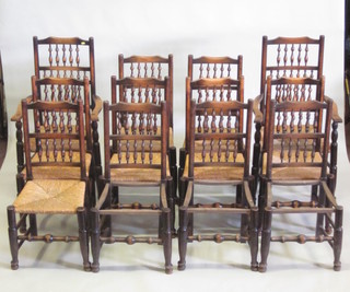 A set of 12 spindle back dining chairs - 2 carvers, 10 standard, 2 requiring woven cane seats