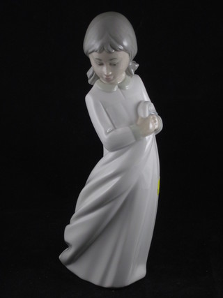 A Spanish porcelain figure of a standing child 9"