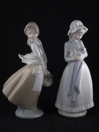 A Nao figure of a standing girl with puppy 9 1/2" and 1 other  girl with basket 9"