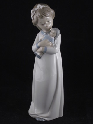 A Spanish porcelain figure of a girl with doll 9"