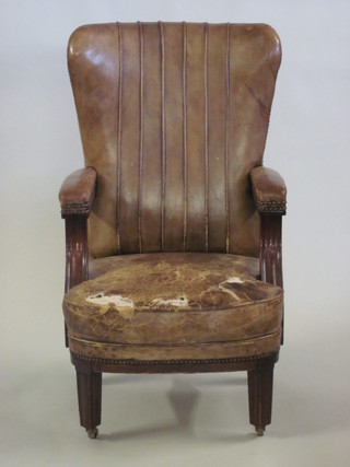 A William IV mahogany open arm chair upholstered in brown leather  ILLUSTRATED