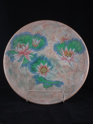 A circular Royal Doulton charger with floral decoration 13"
