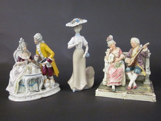 A Continental porcelain figure of a bonnetted lady 11" and 2  other porcelain figure groups 9"