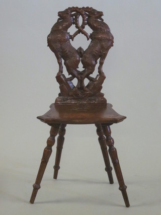 A Continental carved walnut hall chair, the back carved 2 goats  and marked Depose, having a solid seat of serpentine outline,  raised on turned supports