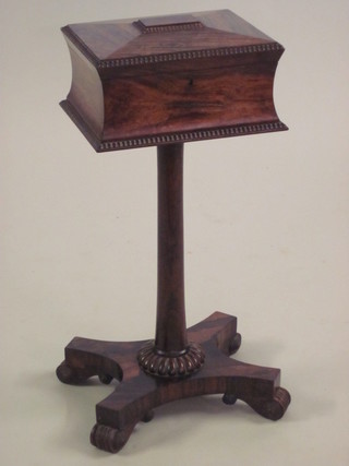 A William IV rosewood teapoy of sarcophagus form with hinged  lid, the fitted interior with glass mixing/sugar bowl, raised on  a turned column with triform base 13"   ILLUSTRATED